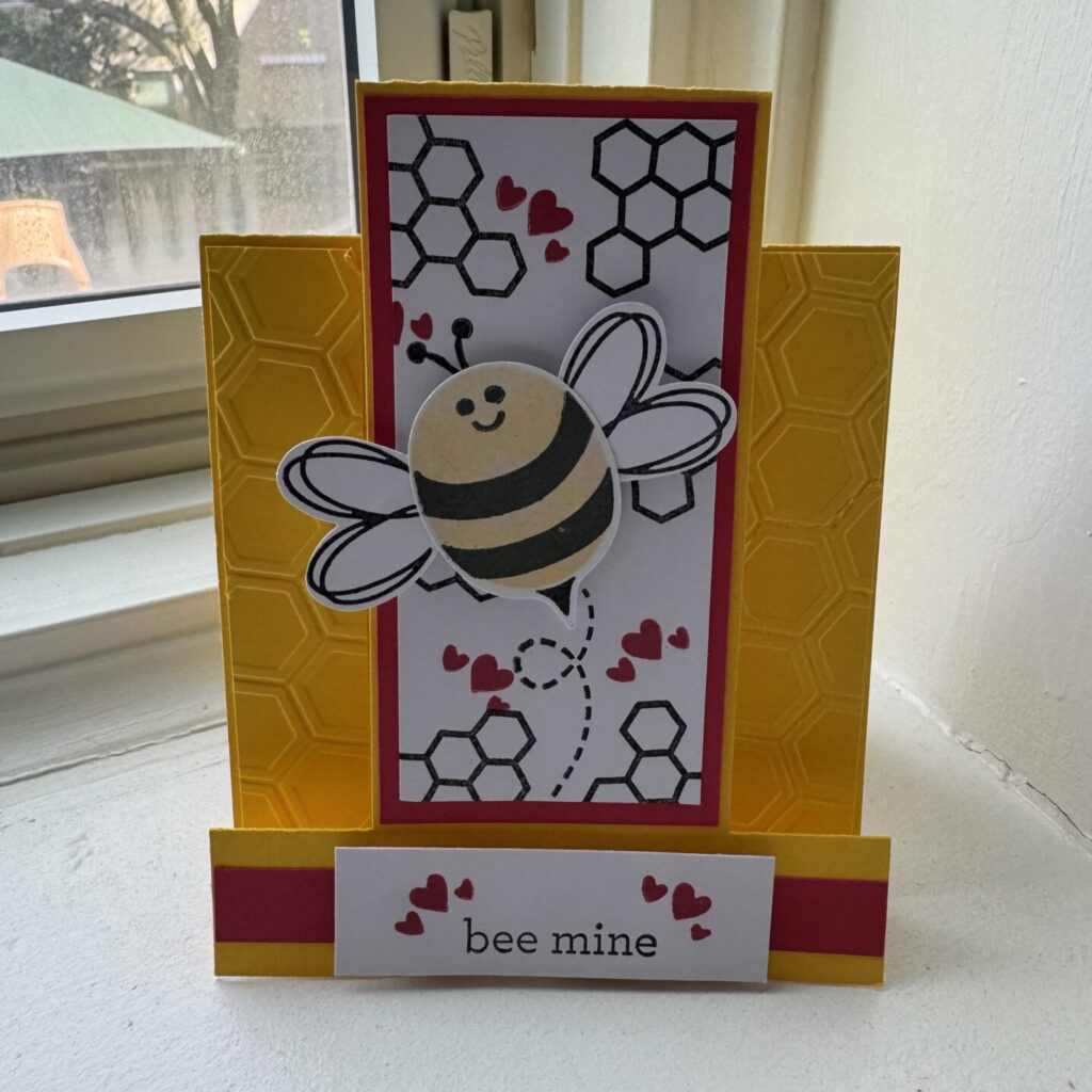 A bee mine card with a picture of a honey bee in flight with hearts